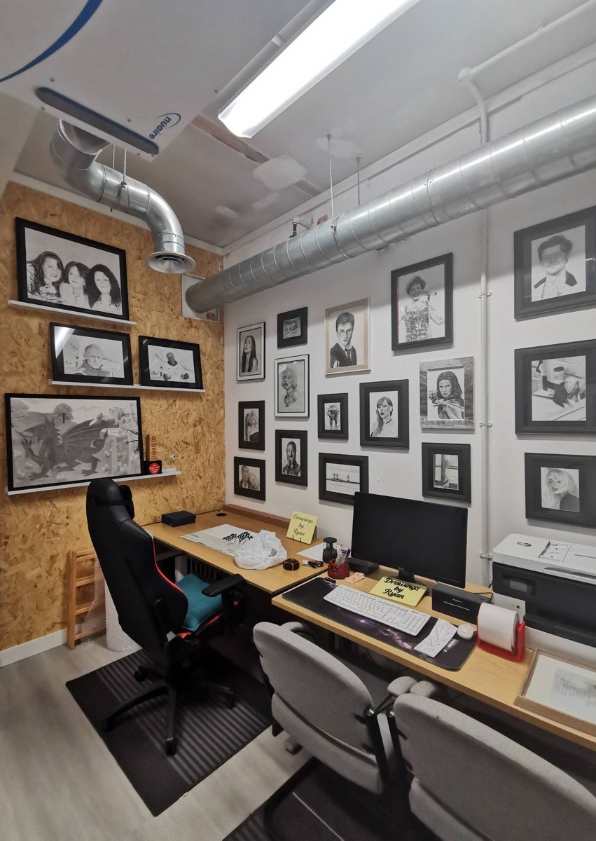 Ryan's studio, filled with framed artwork and drawing materials